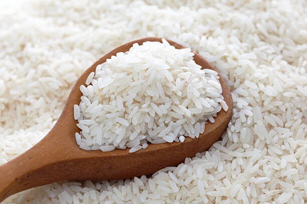 Wooden spoon of white rice
